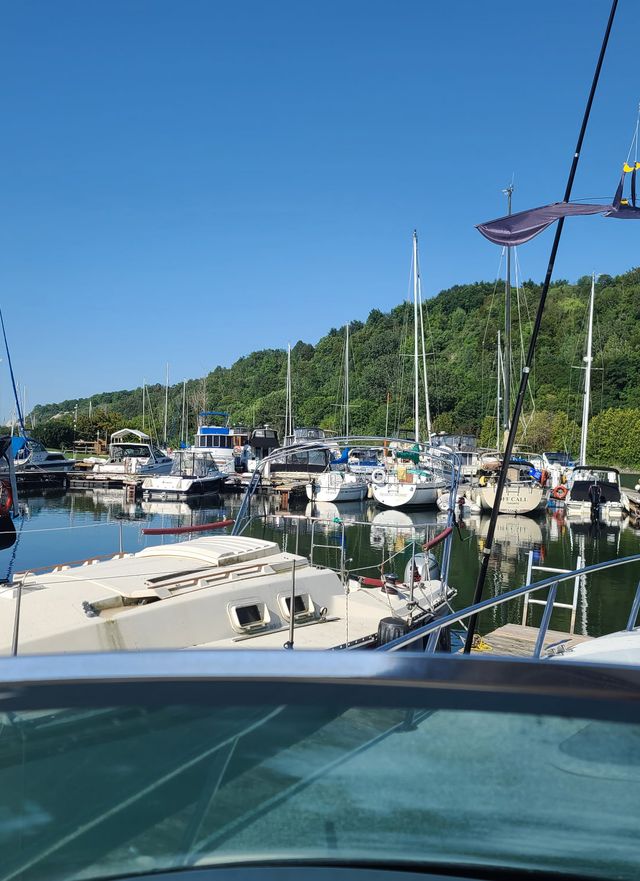 Boats at the docks under a clear sky, seen from a boat deck