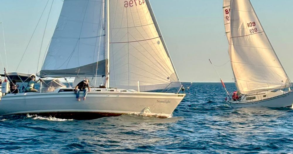 Two sailboats racing on a sunny day