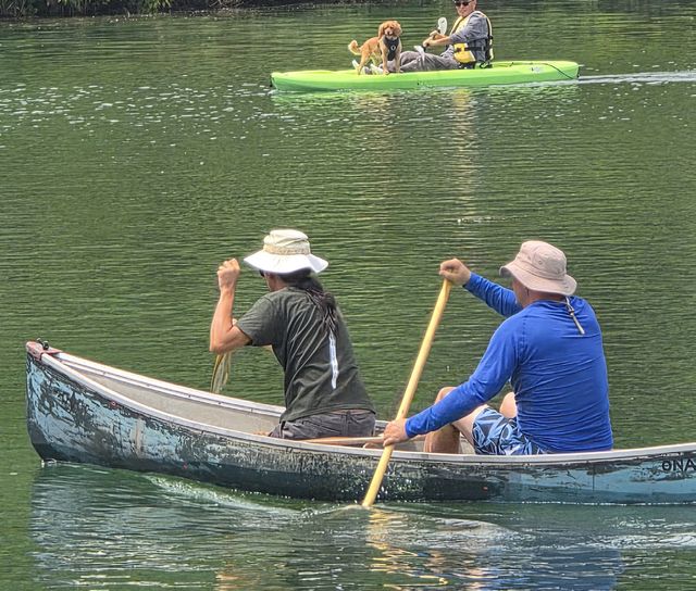 Two members paddling a canoe in the basin