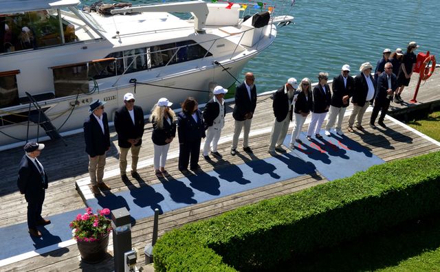 The Board of Directors lined up on the blue carpet at Sailpast