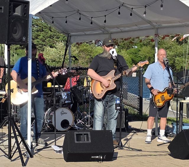 A band playing under a tent at the club