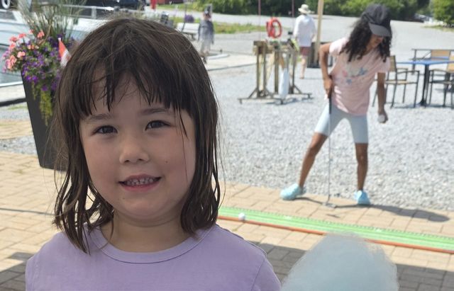 A young girl smiling on the club grounds