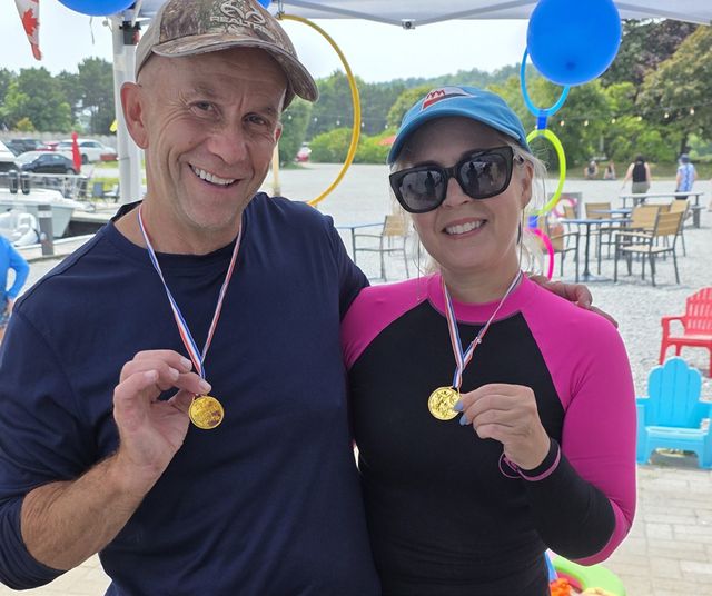Two members showing their medals