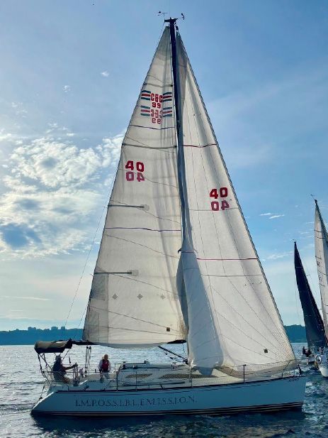 A sailboat under full sail against a blue sky