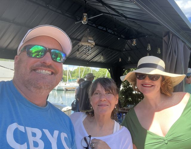 Three members smiling for a selfie