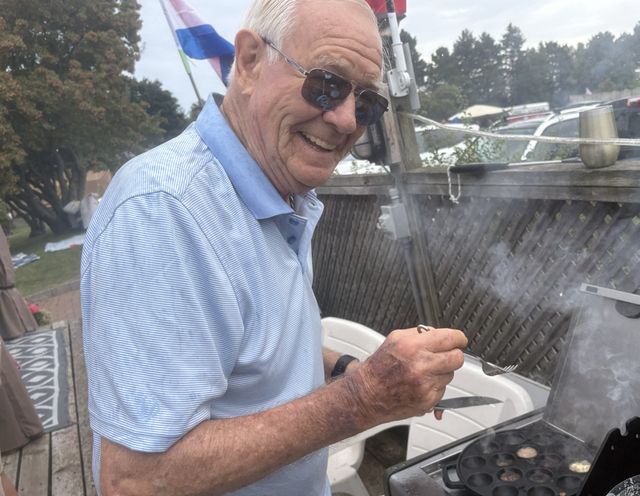 A member grilling at a dockside barbecue